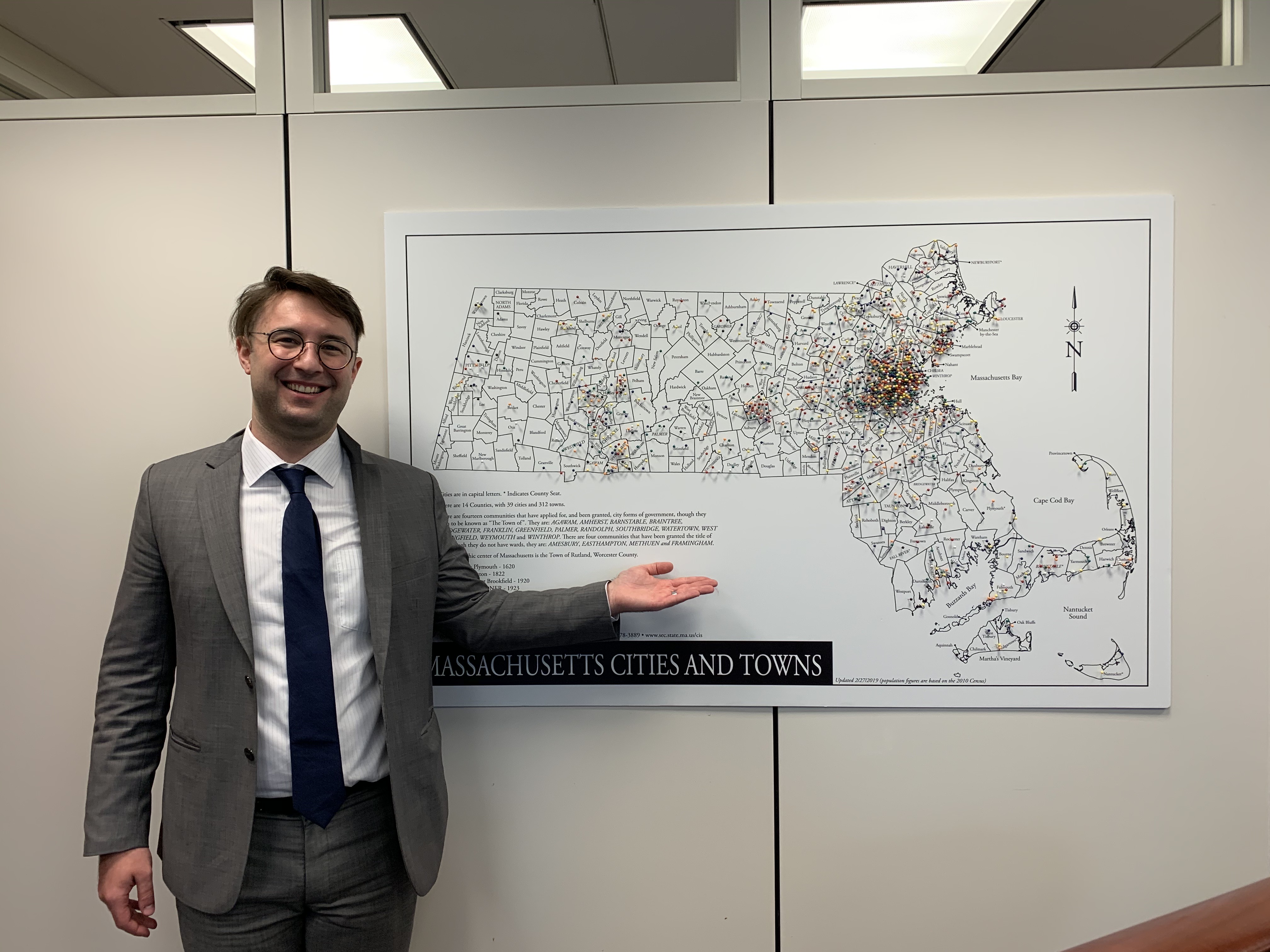 Adam in front of a map of MA.